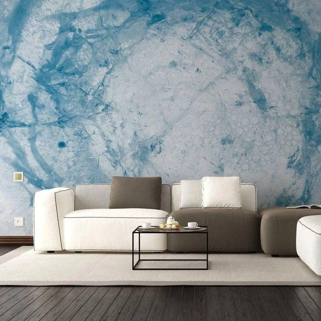 Stylish living room featuring blue marble effect wallpaper and modern furniture.