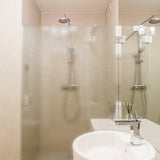 Modern bathroom featuring a frosted glass shower for privacy and natural light.
