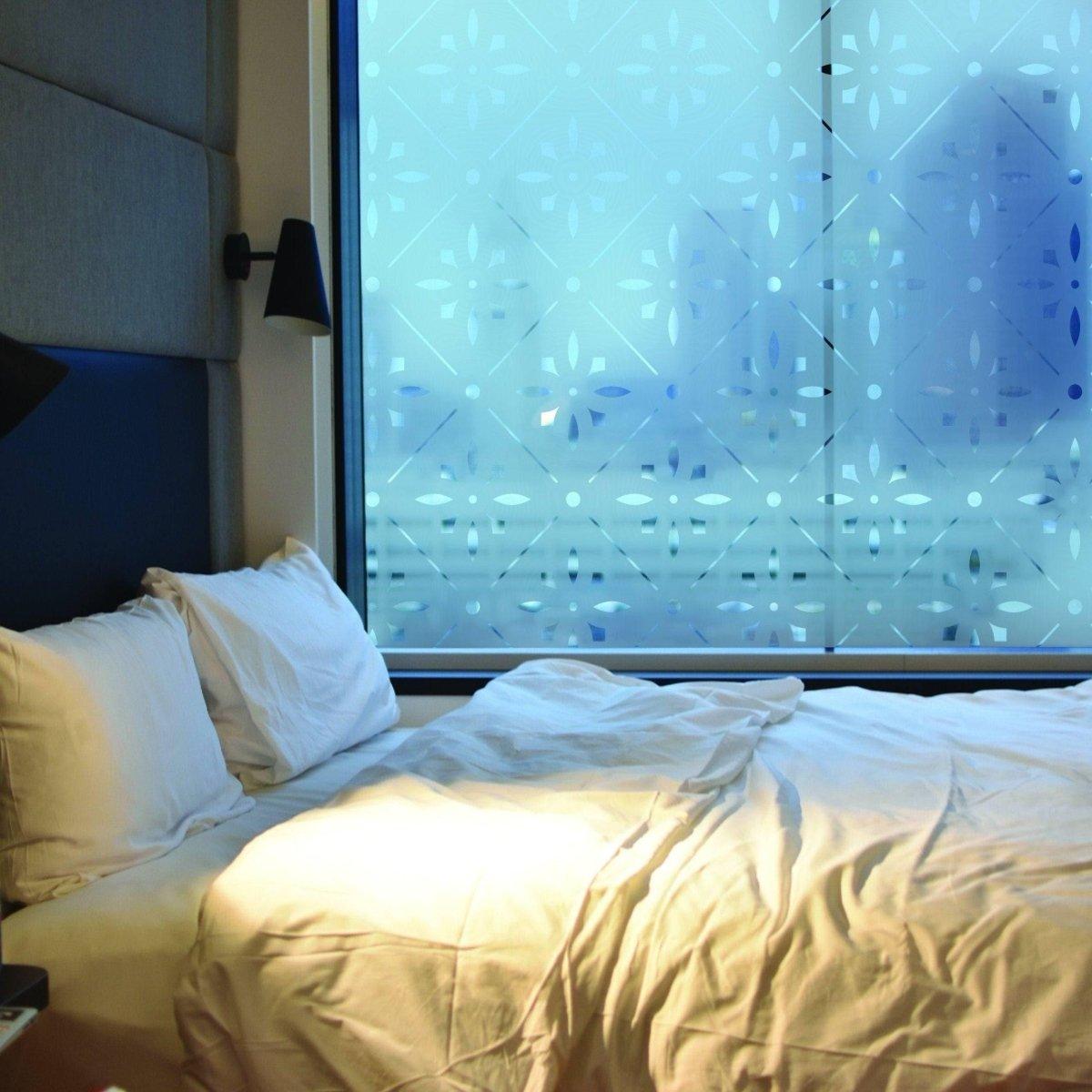 Deluxe geometric frosted window decal on a bedroom window providing privacy and natural light.