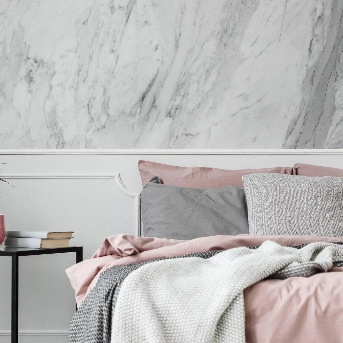 Stylish bedroom featuring marble-pattern adhesive wallpaper and pink bedding for an elegant look.
