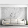 Stylish living room featuring stone-pattern adhesive wallpaper and a modern white couch with decorative pillows.