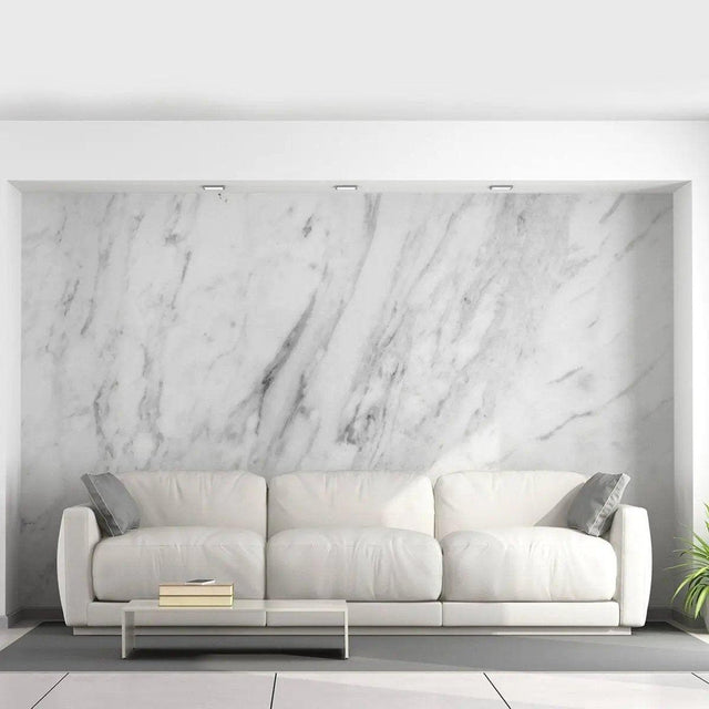 Stylish living room featuring stone-pattern adhesive wallpaper and a modern white couch with decorative pillows.