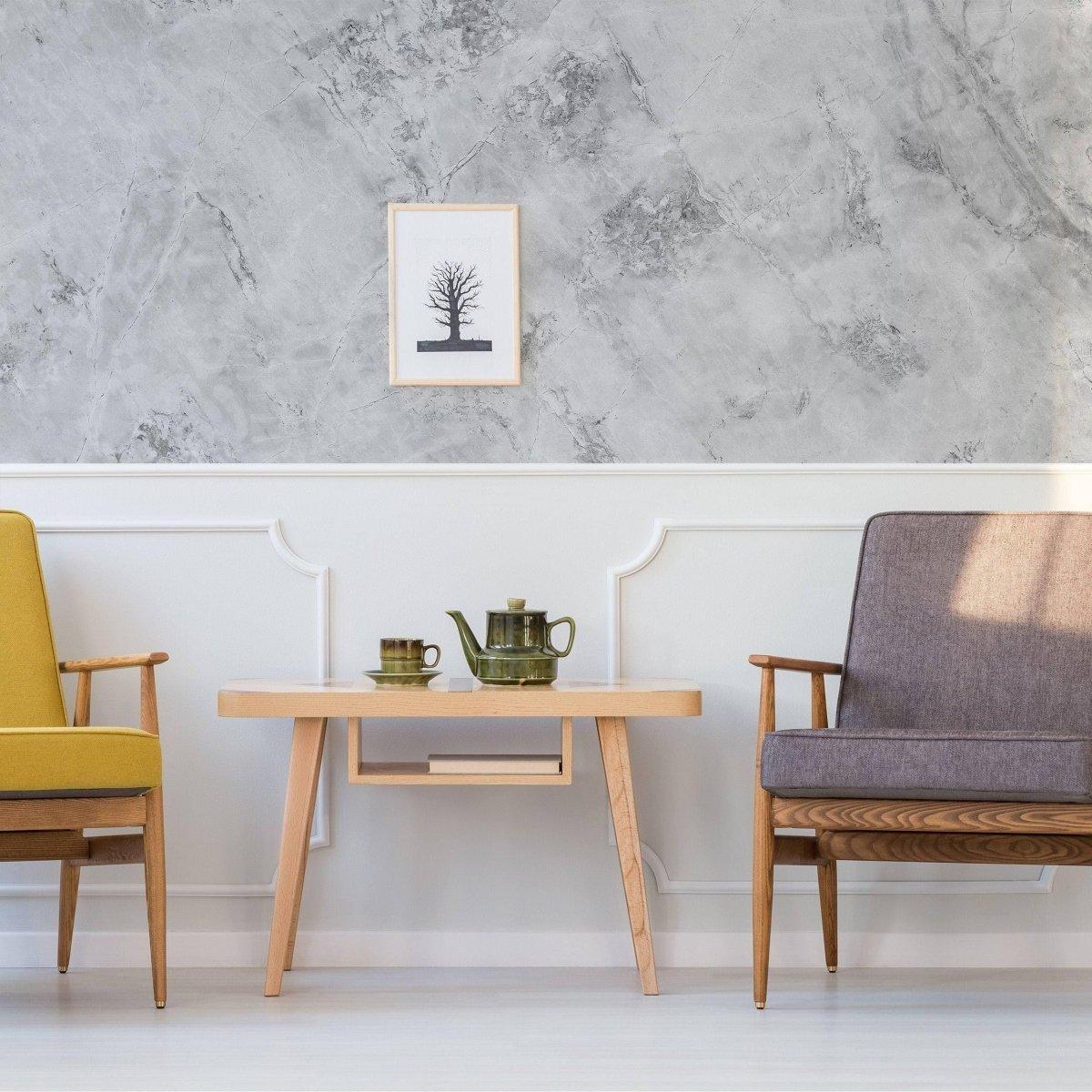 Elegant living room featuring stone texture wallpaper, wooden table, and stylish armchairs.