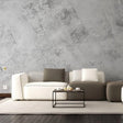 Stylish living room featuring stone texture self-stick wallpaper, modern furniture, and a minimalistic coffee table.