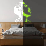 Glow in the dark wall decal of a singing woman, enhancing bedroom ambiance with luminous art.