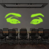 Glowing luminescent woman eye vinyl wall decal in a modern conference room setting.