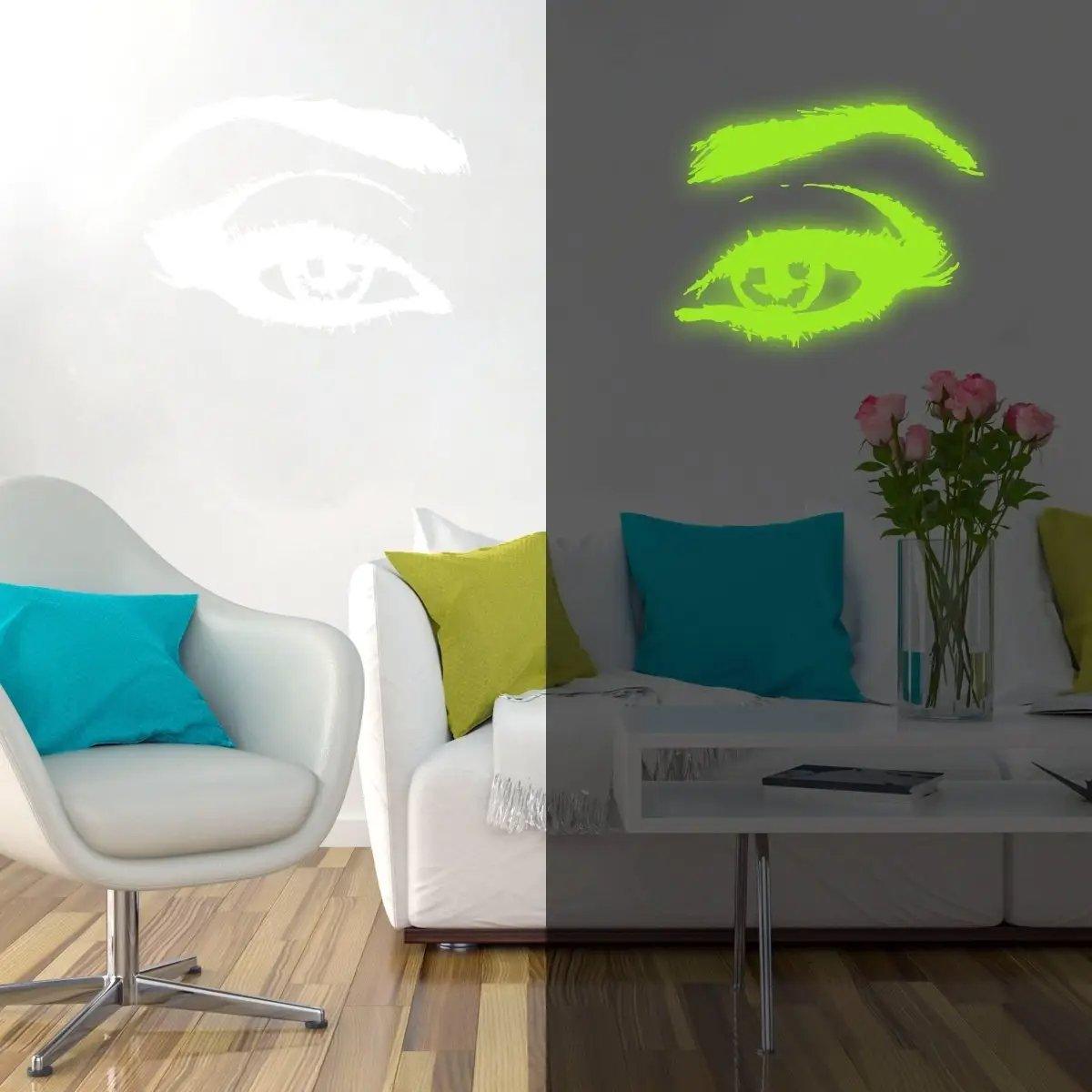 Glowing luminescent eye vinyl wall decal illuminating a modern living room space with vibrant colors.