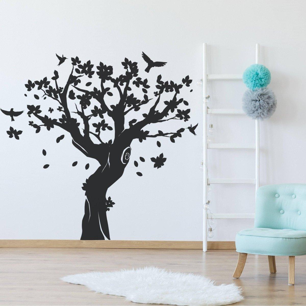 Contemporary tree wall art sticker in a nursery, featuring birds and flowers.
