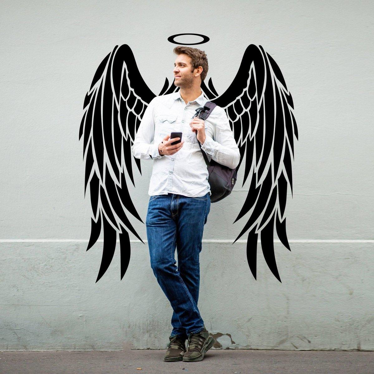 Man standing with angel wings wall sticker, offering a whimsical touch to any space.