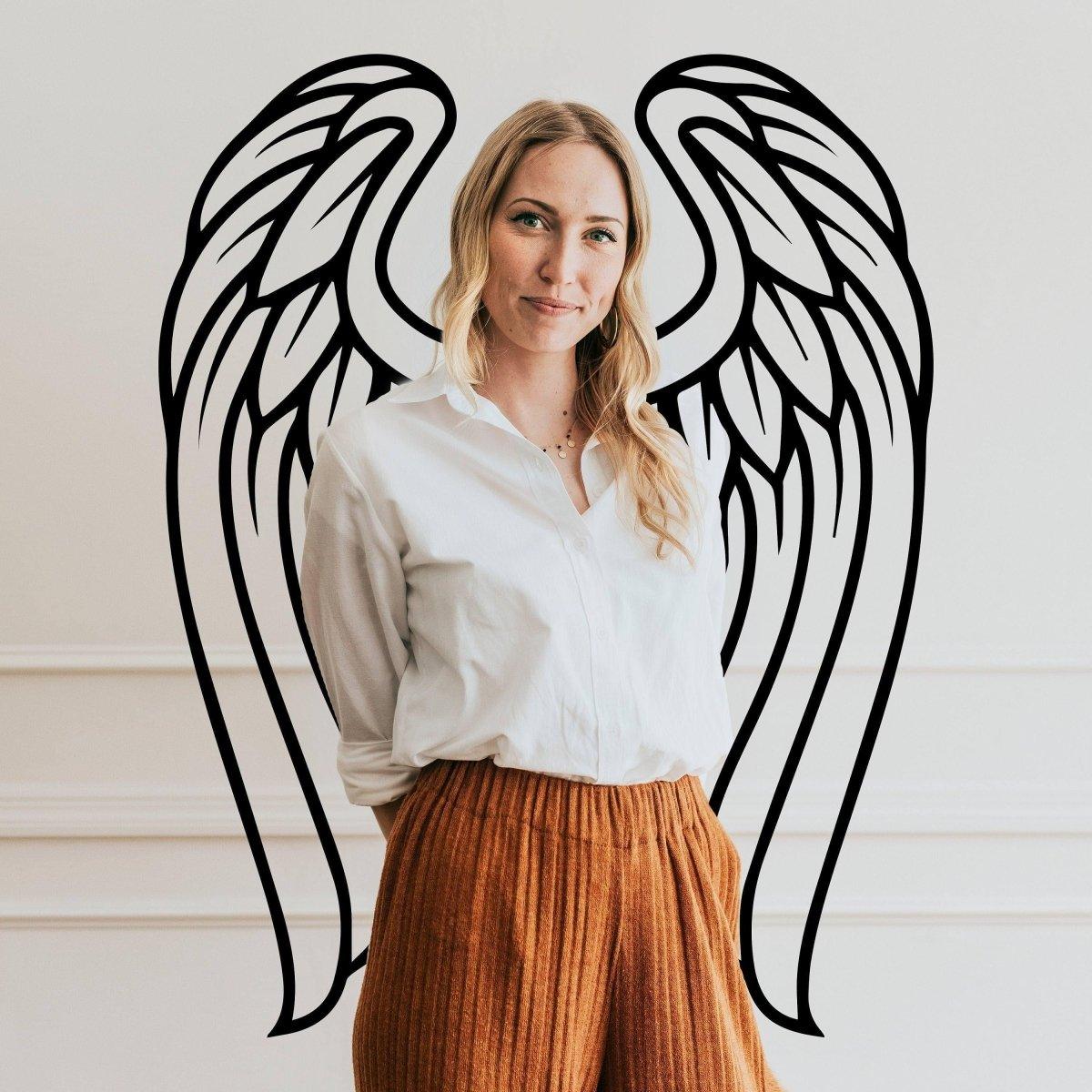 Woman standing in front of Angel Wings Wall Decor, showcasing Bohemian style and feathered serenity in home decor.