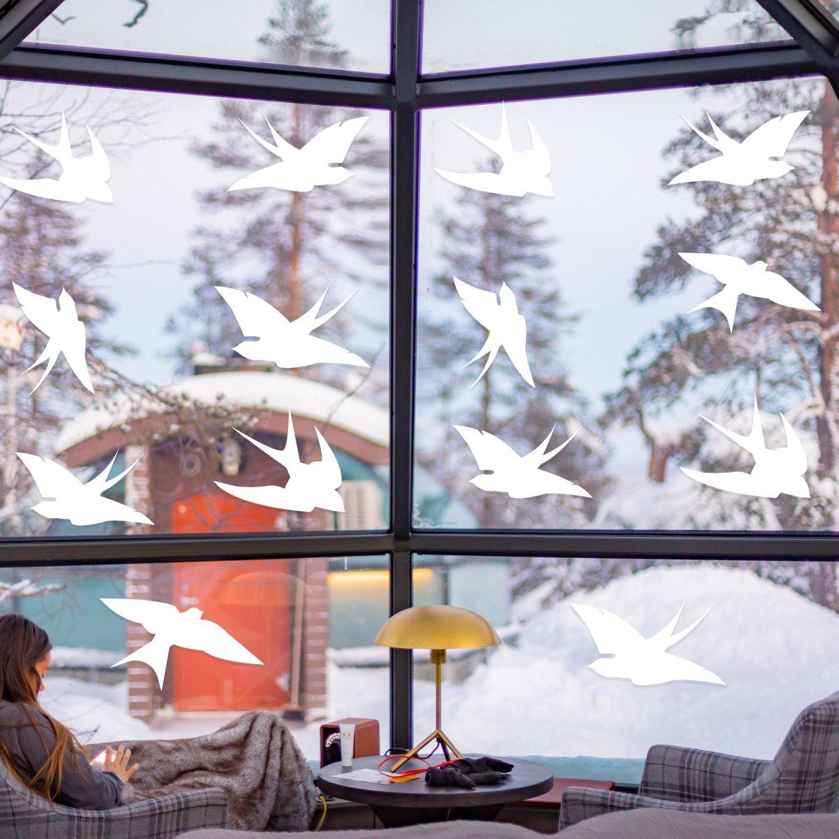 White bird safety window decals by FeatherGuard on a large window, enhancing bird awareness and home aesthetics.