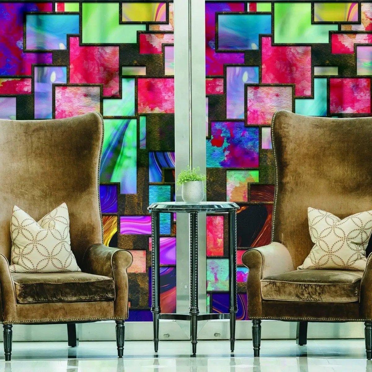 Frosted privacy window film featuring colorful geometric design with elegant armchairs and side table in modern interior.