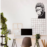 Stylish home office featuring a Queen Monkey vinyl wall art decal above a minimalist desk.