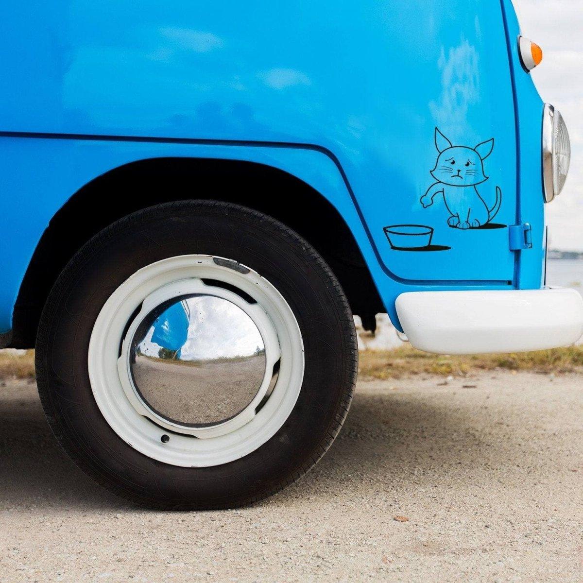 Cute cat vinyl decal on a blue vehicle, adding playful personality to the car.