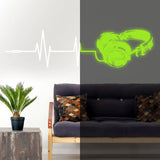 Vinyl wall decal of glowing headphones and sound wave design in modern living room decor.