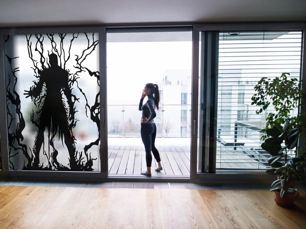 Frosted vampire silhouette window decal adding gothic elegance to a chic modern space.