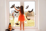 Bat-shaped vinyl decals displayed on a window.