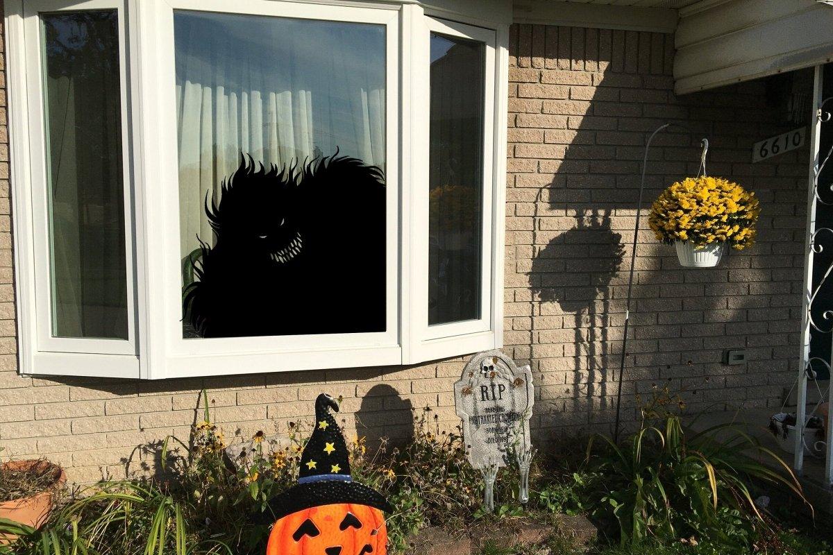 Spooky monster silhouette window decal for Halloween decor.