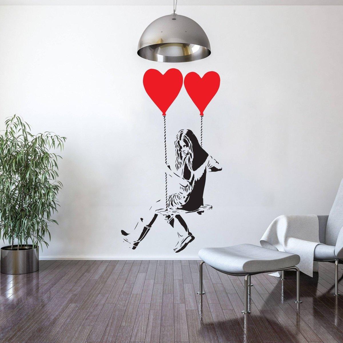 Vinyl heart balloon wall decal featuring a girl swinging with red heart balloons.
