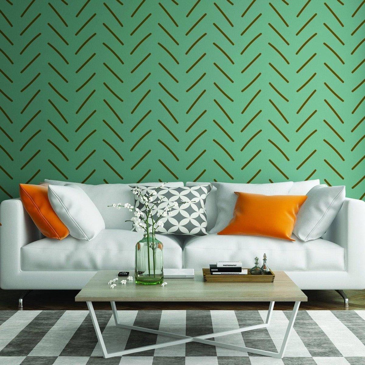 Living room featuring herringbone peel and stick wall stickers in green, with a stylish white sofa and decorative pillows.