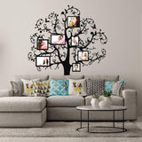 Family vinyl wall decal featuring a tree design for displaying photos above a modern couch and decorative pillows.