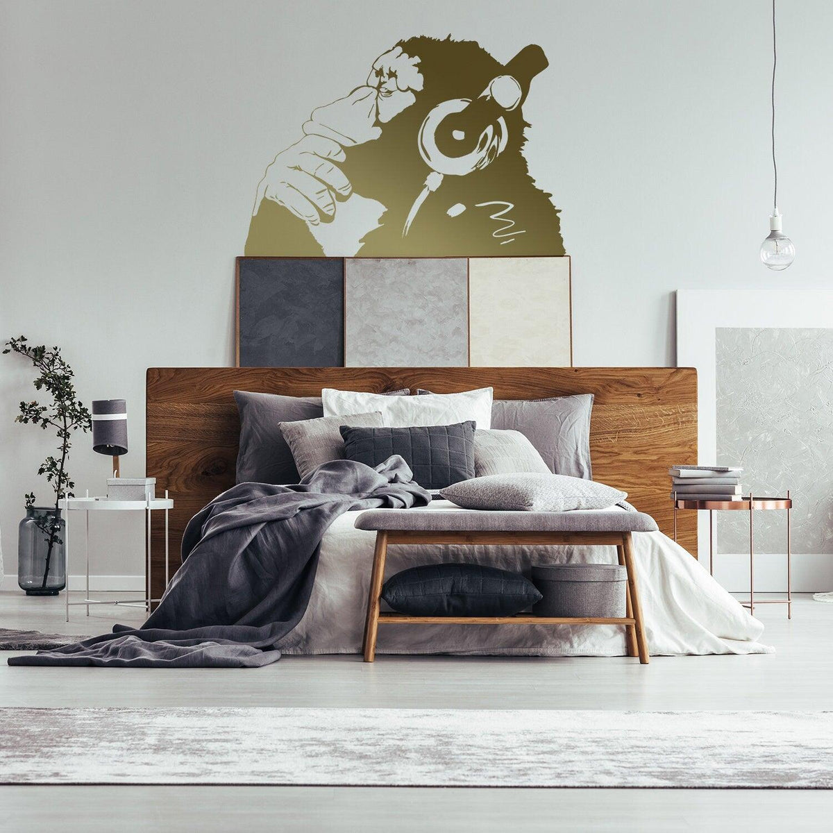 Thinking monkey wall sticker displayed above a bed.