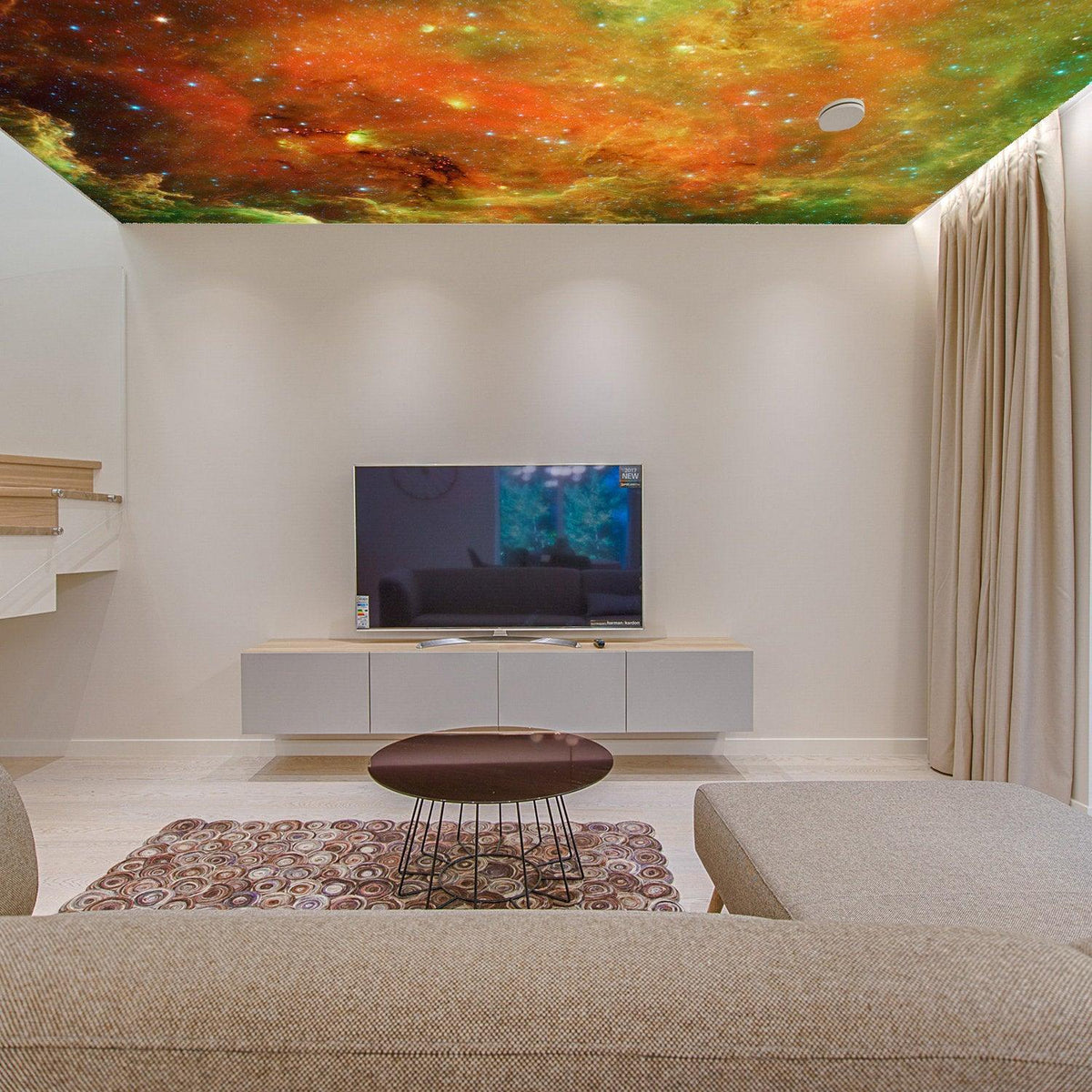 Colorful space theme ceiling vinyl sticker depicting galaxies and stars in a modern living room decor.
