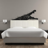 Black alligator wall sticker above a white bed, adding a unique touch to bedroom decor.