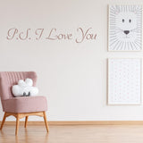 P.S. I Love You wall sticker in a cozy romantic bedroom decor with cute art prints and chair.