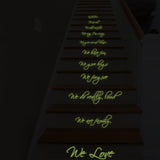 Glow in the dark vinyl stair sticker with family quotes on wooden staircase, enhancing home decor.