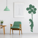 Balloon girl vinyl wall sticker in a green nursery.