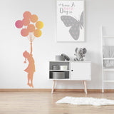 Balloon girl wall sticker in a nursery with colorful balloons.