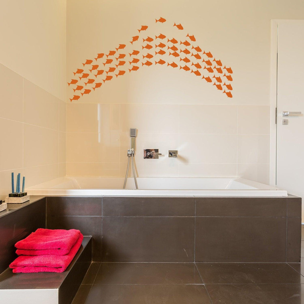 Fish vinyl wall sticker set in a modern bathroom above a bathtub, adding a fun ocean theme to the decor.
