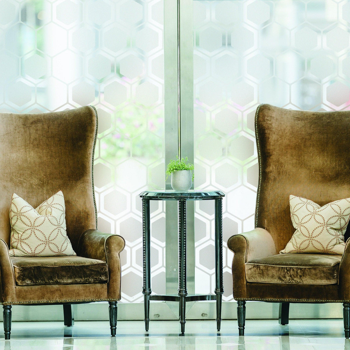 Elegant living room featuring two high-back chairs with stylish cushions and a decorative table.