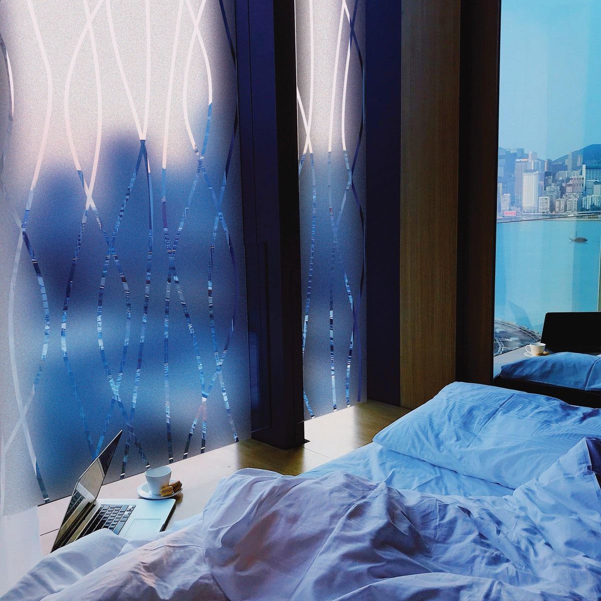 Frosted glass window decal in a modern bedroom with a scenic view, enhancing privacy and style.