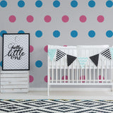 Kids room decor featuring colorful round wall decals, a crib, and playful wall art for a nursery.