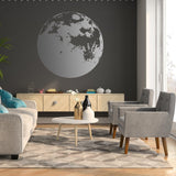 Stylish living room with a large moon phase wall decal on dark wall and modern furniture, creating a cozy atmosphere.