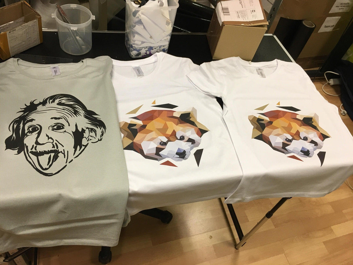Custom t-shirts featuring unique designs: a cartoon Einstein and geometric animal graphics.