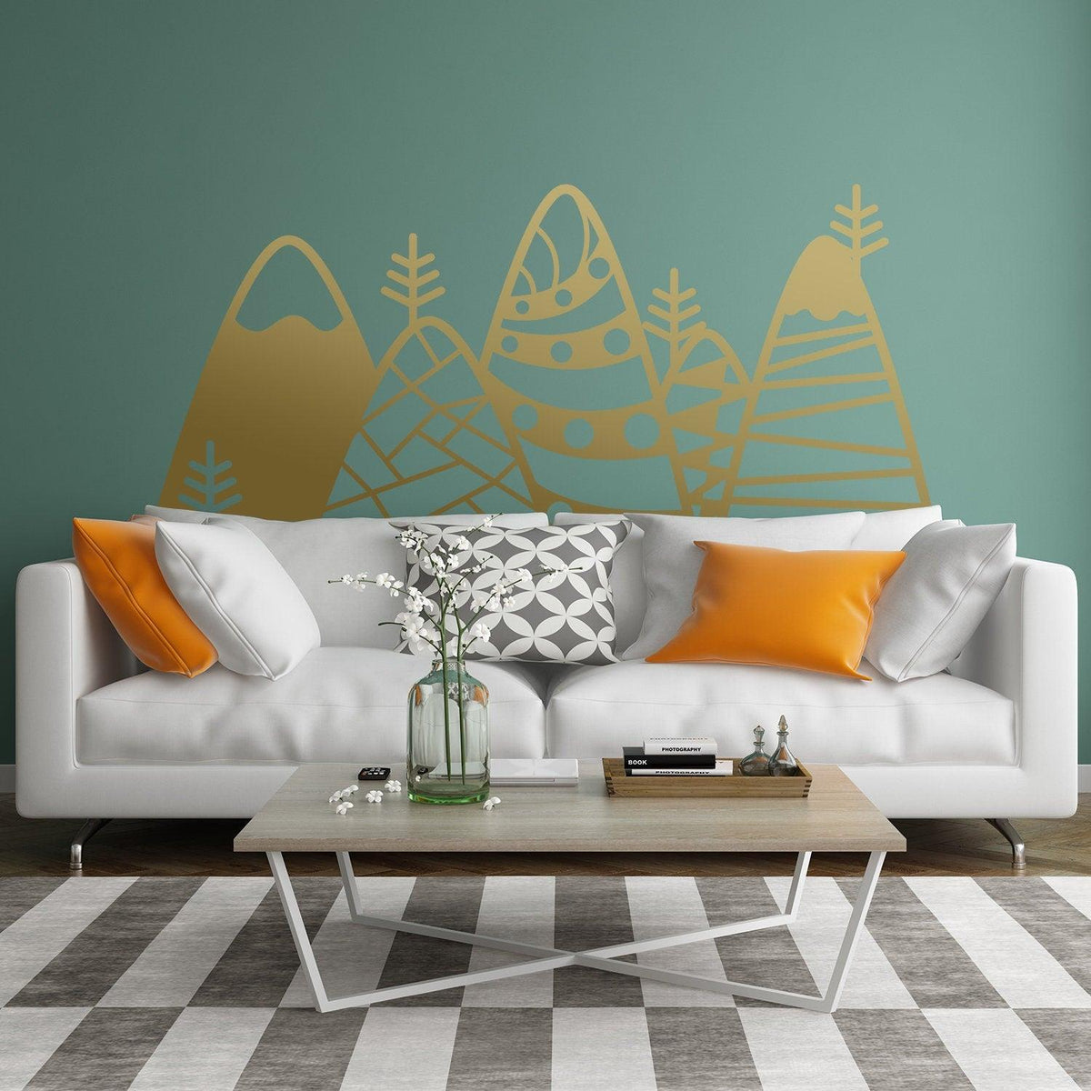 Patterned mountain wall decor vinyl decal in a kid's room above a modern sofa with orange pillows.