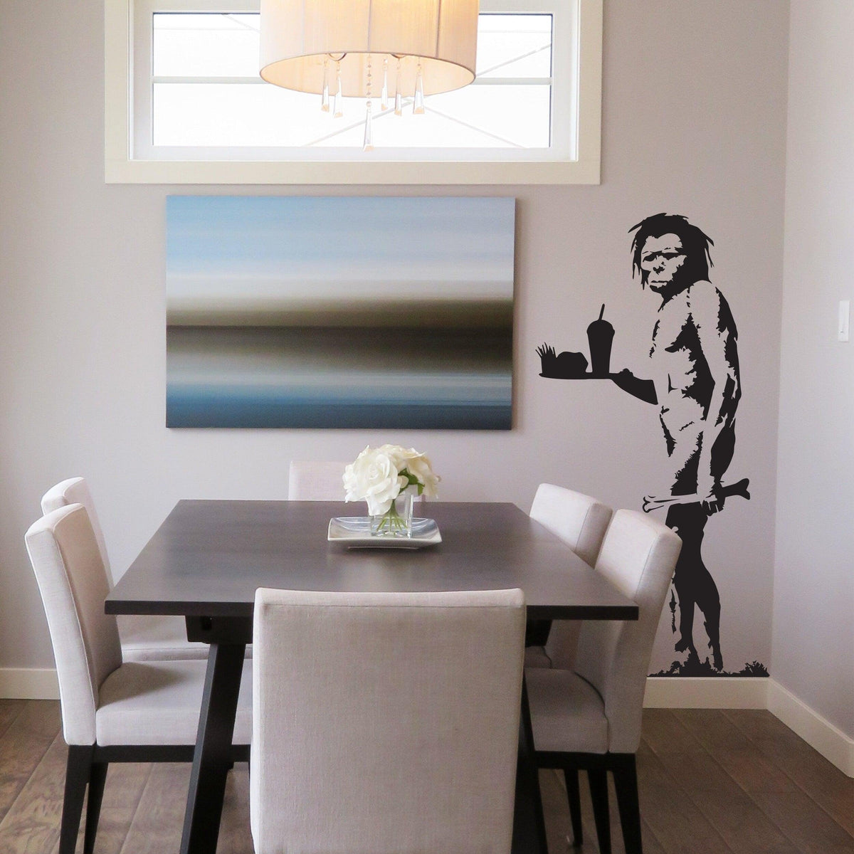 Caveman wall decal displayed above a sofa.