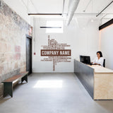 Custom business name vinyl wall sticker in modern office setting with professional decor.