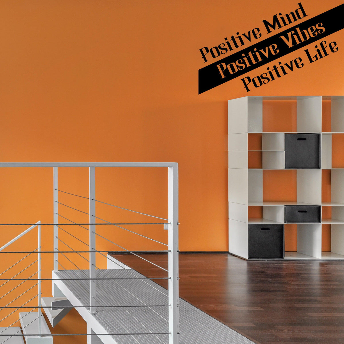Inspirational wall decor with positive quote sticker on orange wall in modern interior design.