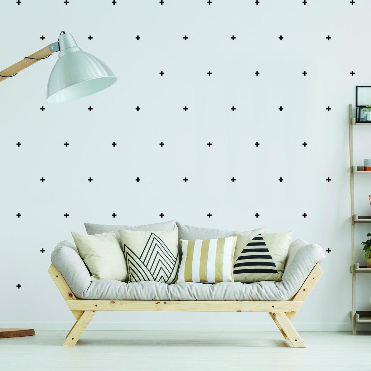 Stylish living room featuring 50x cross sticker vinyl wall decor on white walls and modern sofa with decorative pillows.