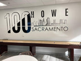 Interior view of a wall featuring '100 Howe Sacramento' mural with city skyline design.