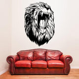 Large lion head wall decal above a red leather couch in a stylish living room setting.