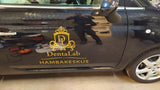 Custom business vinyl decal displayed on a black vehicle.