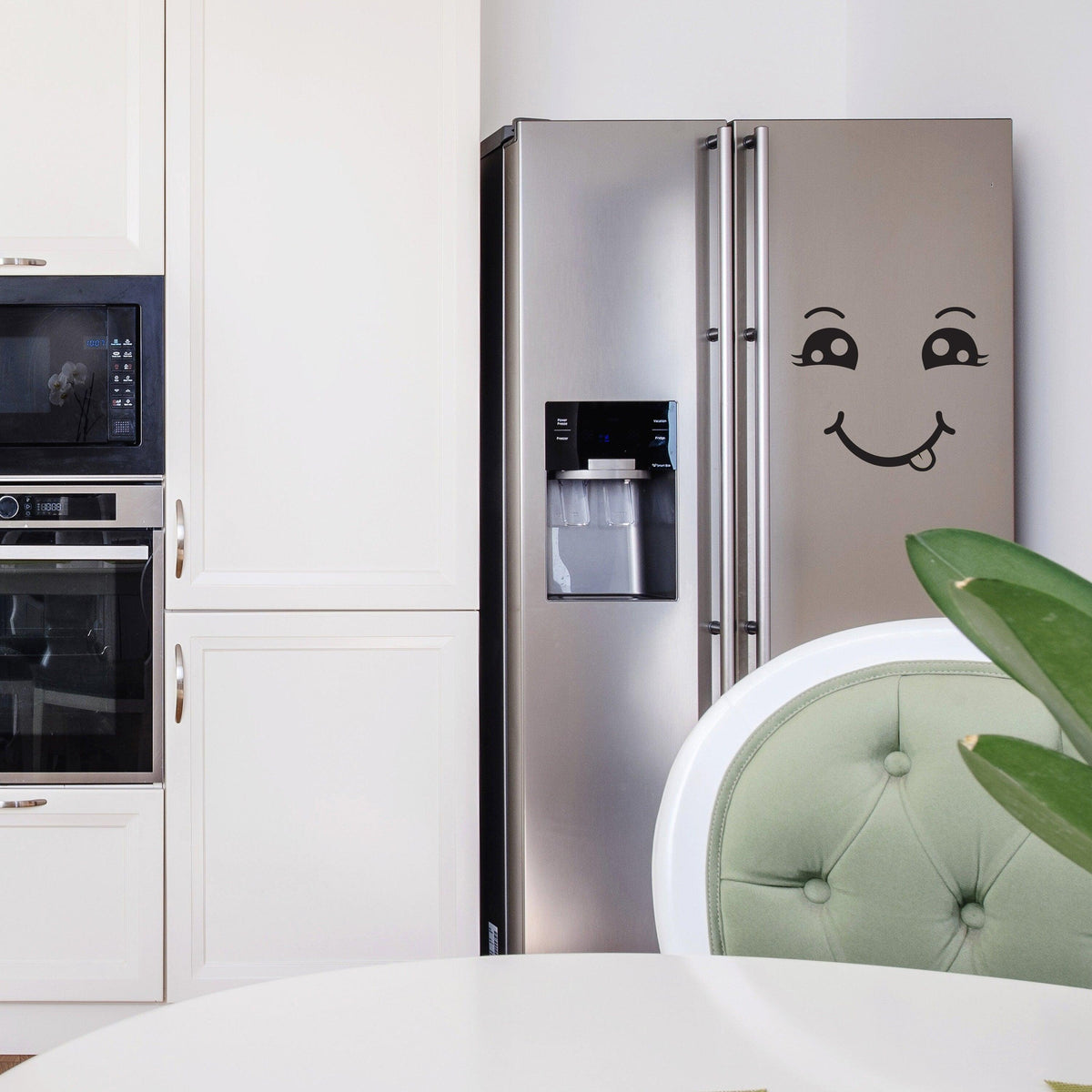 Happy face vinyl decal on stainless steel refrigerator, adding a cheerful touch to modern kitchen decor.
