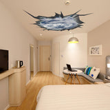 3D ceiling sticker of a blue sky porthole in a modern bedroom, creating a unique decor illusion.
