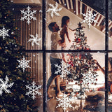 Family decorating a Christmas tree with snowflake window stickers visible on the glass for a festive holiday atmosphere.