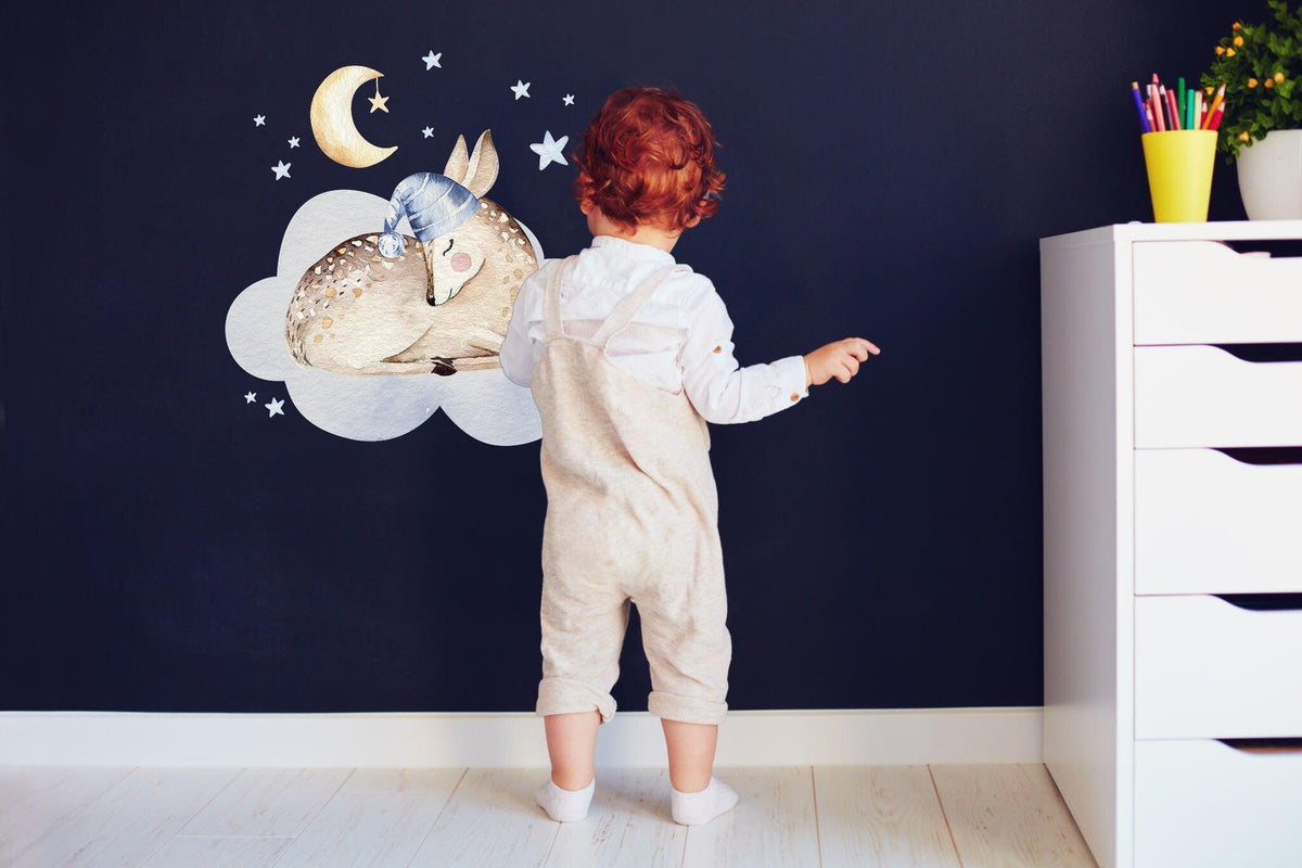 Baby nursery wall decor sticker with a deer, cloud, moon, and stars, enhancing a child's room atmosphere.